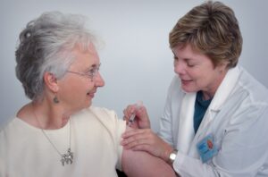 Old woman receiving her flu shot